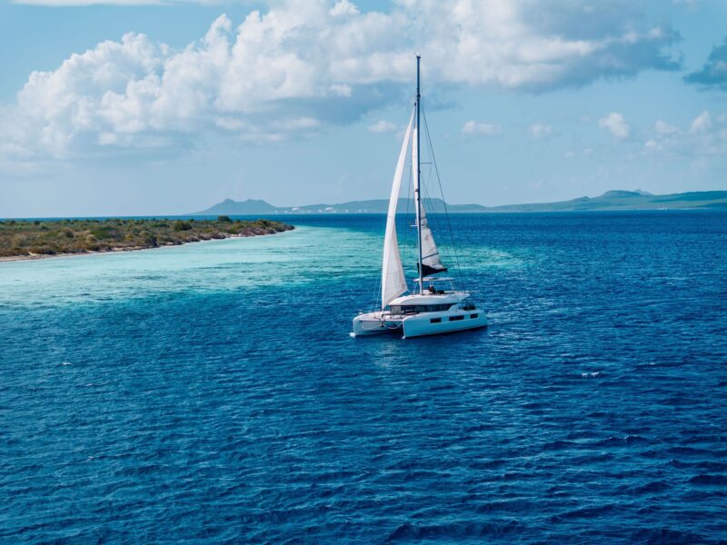 Catamaran sailing along Bonaire's reef with Klein Bonaire in the distance