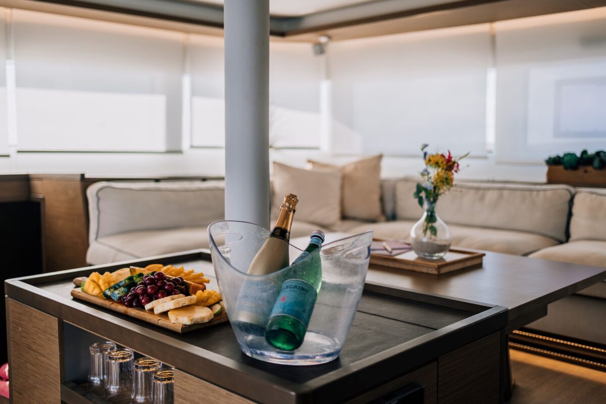 Champagne and fruit board in the salon of a private catamaran charter