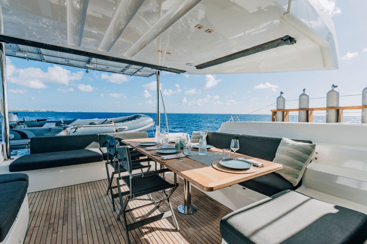 Alfresco dining table on the aft deck of a private catamaran charter in Bonaire