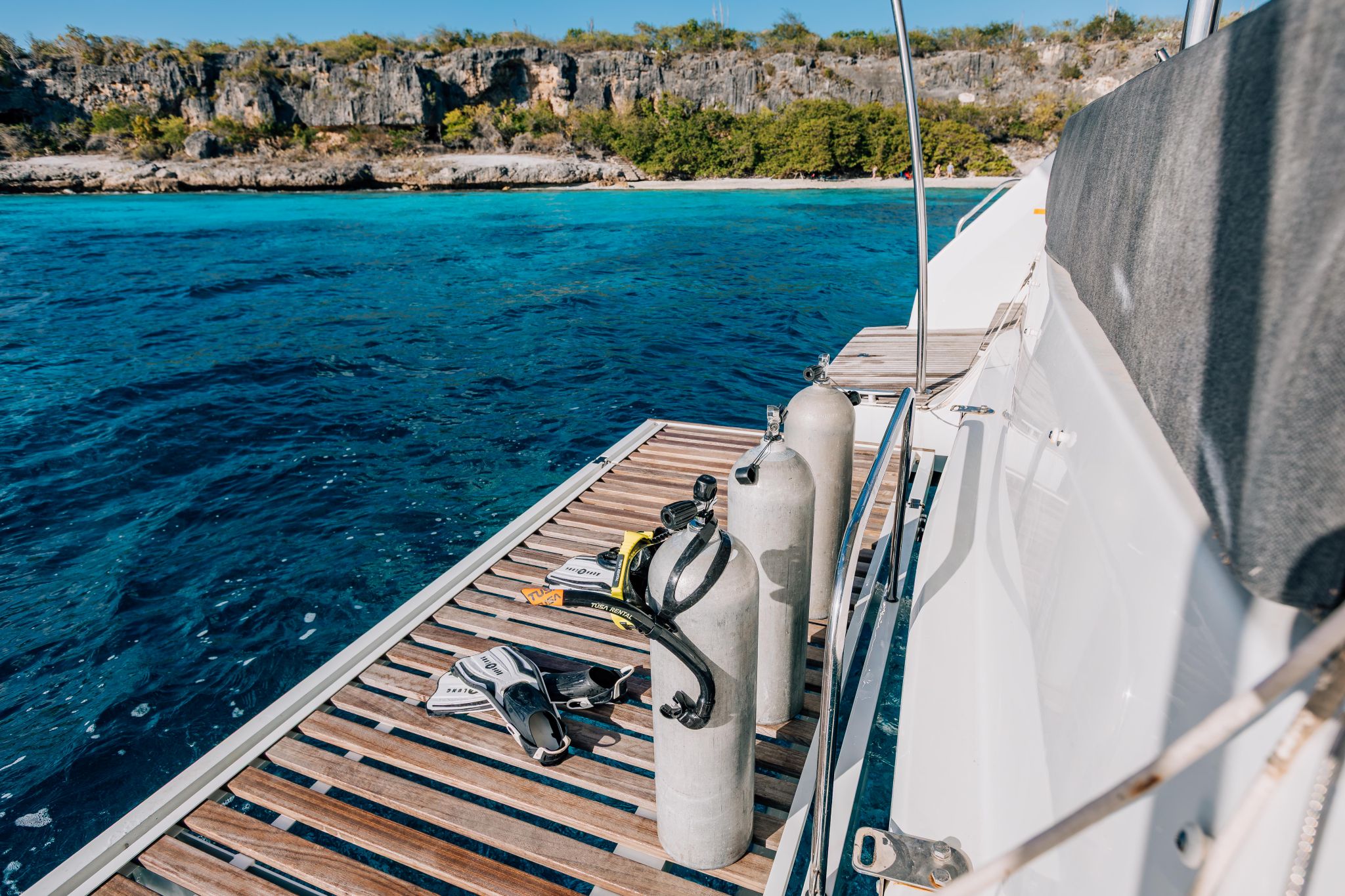 scuba tanks and fins on the swim platform of a multi-day private catamaran charter